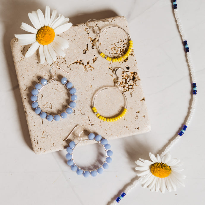 Anasu Jewellery Set. Cornflower Blue Jaipur Hoops from the India Collection. Yellow Shine Hwange Hoops and White and Blue Zambezi Necklace from the Zimbabwe Collection. ANASU
